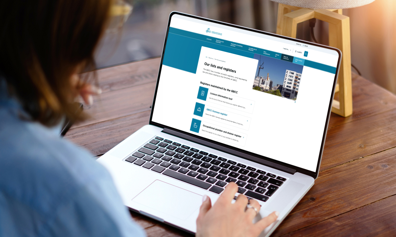 Woman looking at the QBCC's Lists and Registers page on a laptop