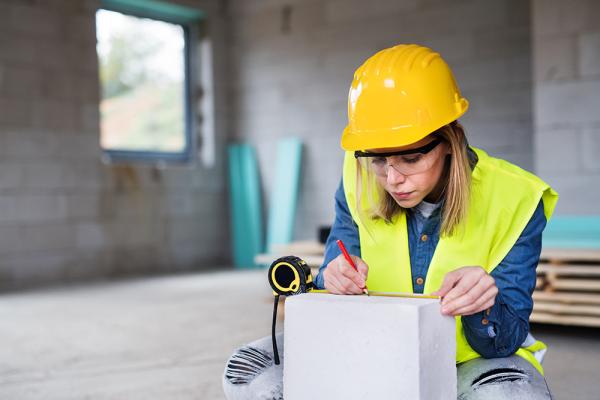 woman builder construction measuring tape