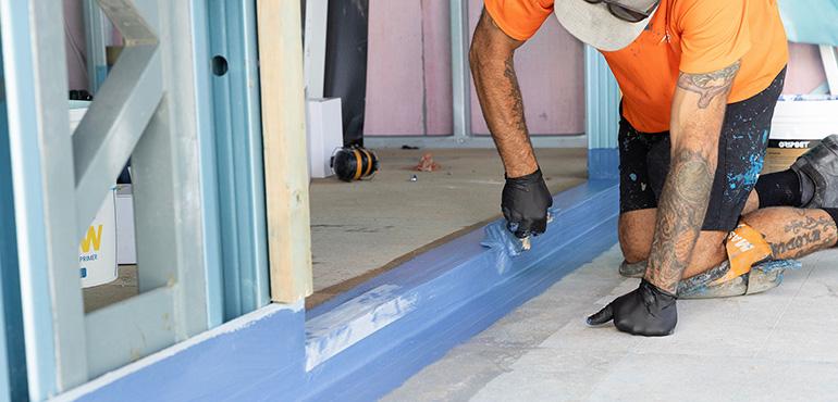 waterproofing frame tradesperson painting
