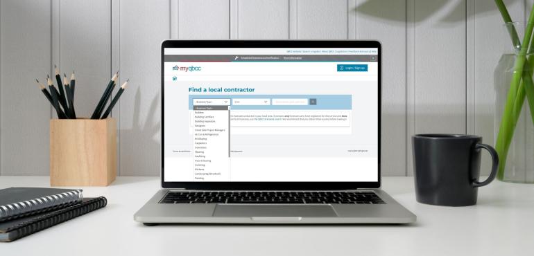 Laptop open on the Find a Contractor website in an office