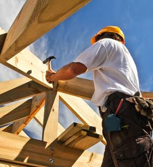 Carpenter nailing wooden frame